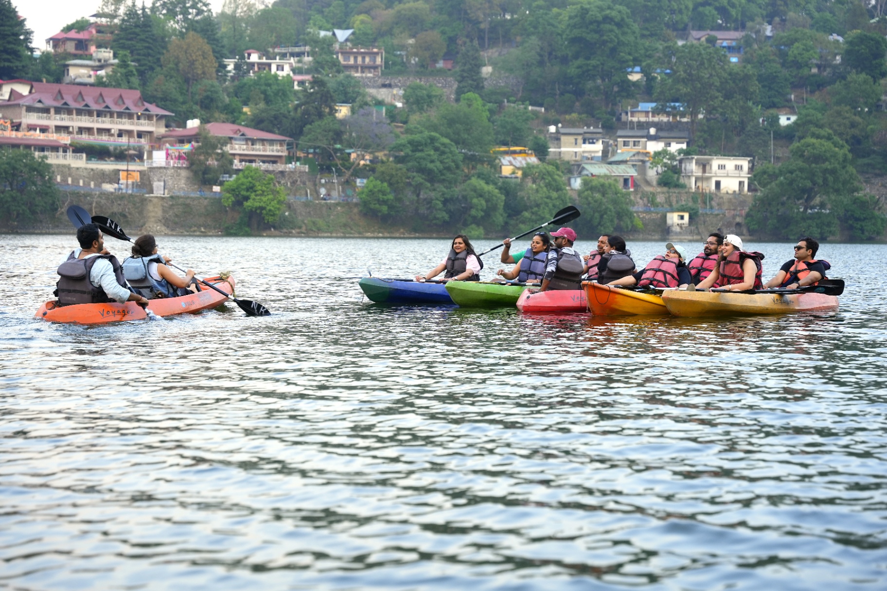 Group kayaking together on a mountain lake